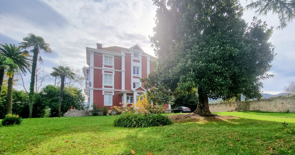 Fachada principal de La Casa Roja, una elegante casa indiana de color rojo en Ribadedeva, Asturias, ejemplo del esplendor modernista del siglo XX.